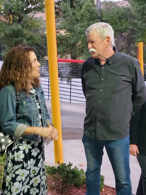 A photo of individuals talking.