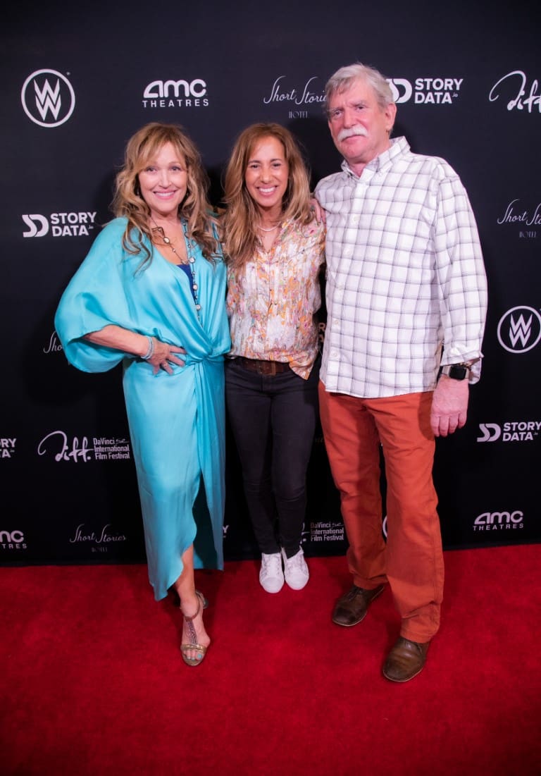 A photo of Tamara, Marc, and a guest on the red carpet.