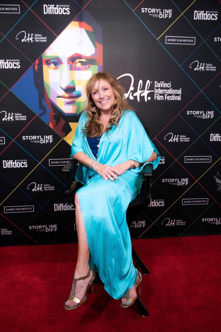 A photo of Tamara smiling on the red carpet.